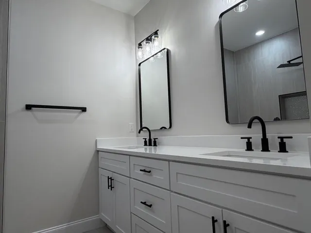 a bathroom with a double vanity sink and a mirror