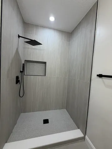 a bathroom with a shower and a sink