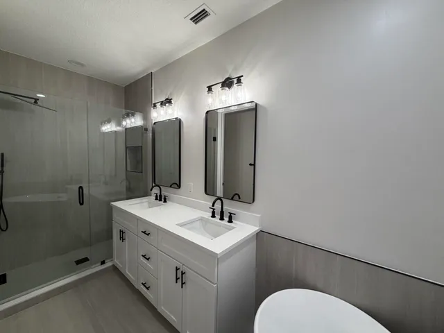 a bathroom with a toilet sink and mirror