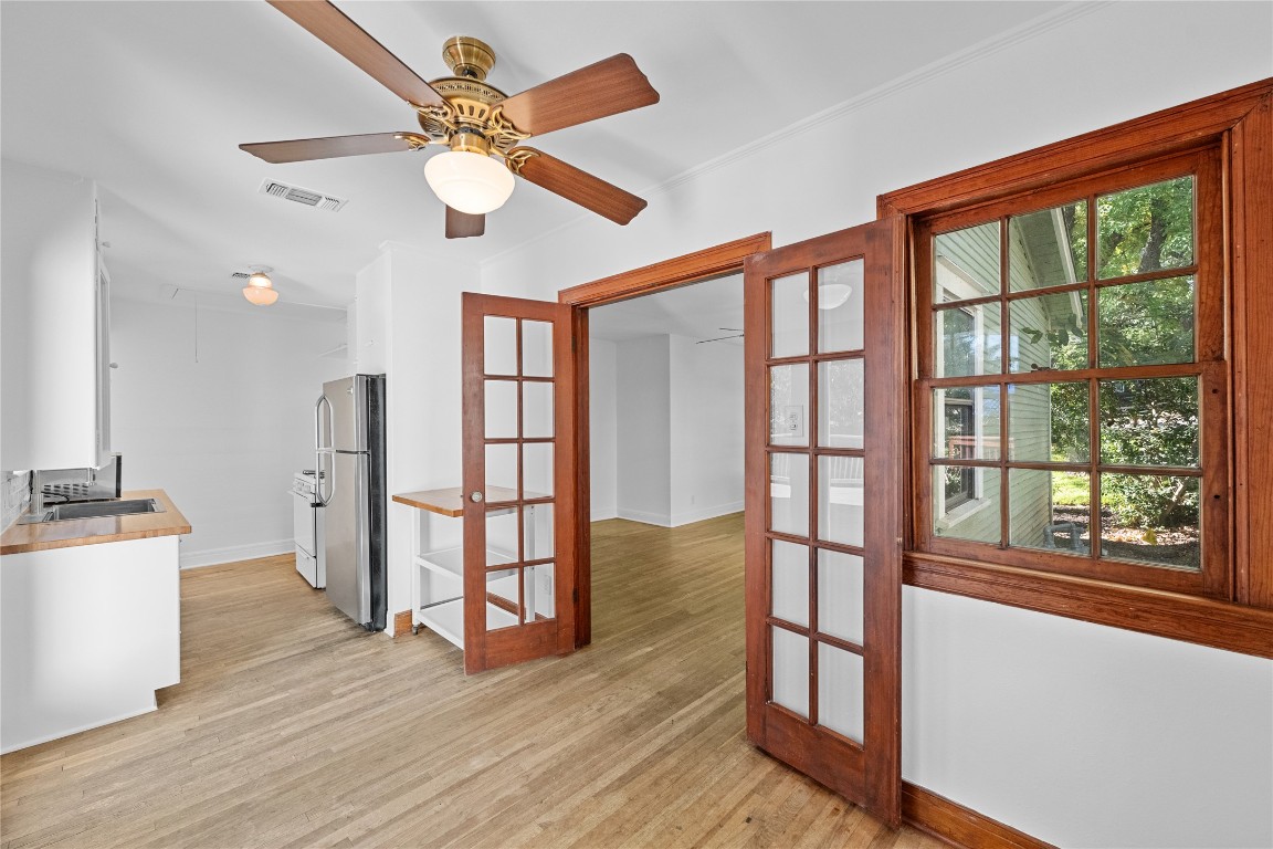 516 Lockhart Drive Austin, TX 78704 - Photo 11 of 25 a view of empty room with wooden floor and fan