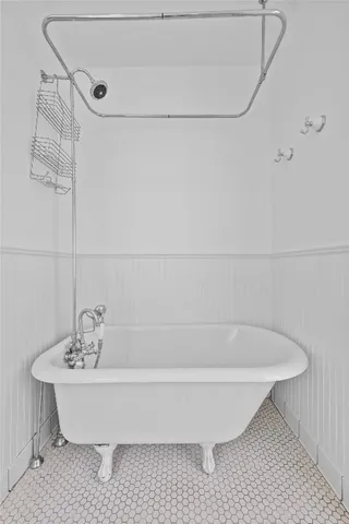 a bathroom with a bathtub and shower