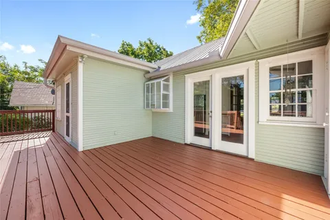 a view of backyard with a deck and wooden floor