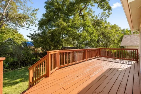 a balcony with wooden floor and fence