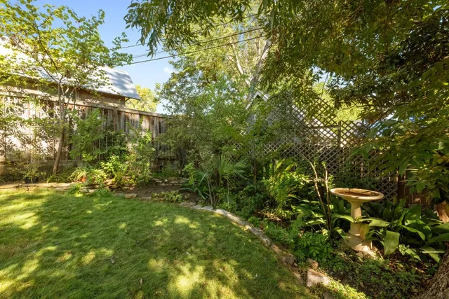 a view of a house with a yard and deck