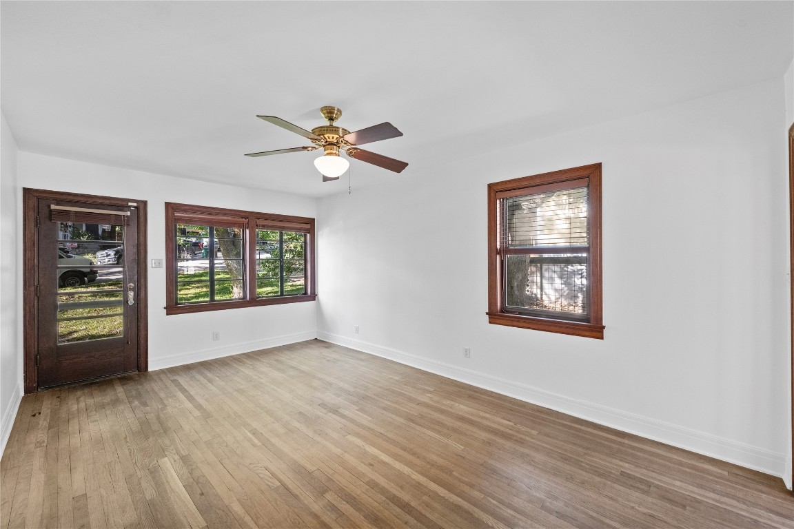 516 Lockhart Drive Austin, TX 78704 - Photo 3 of 25 a view of an empty room with a window and wooden floor