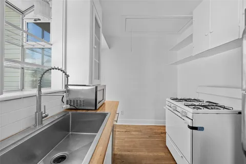 a kitchen with a sink and a stove top oven