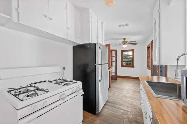 a kitchen with a stove a refrigerator and a sink