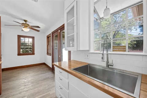 a view of a kitchen cabinets a sink and wooden floor