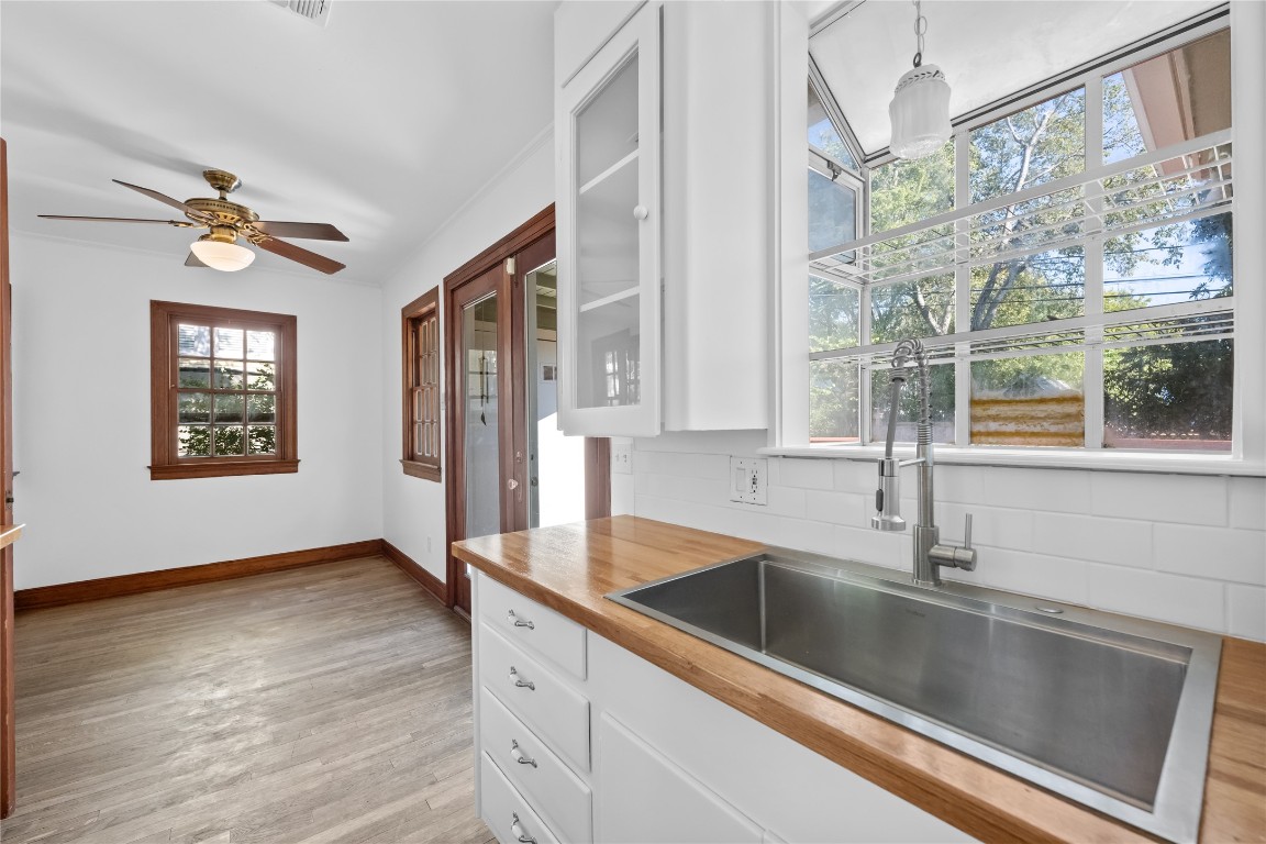 516 Lockhart Drive Austin, TX 78704 - Photo 10 of 25 a view of a kitchen cabinets a sink and wooden floor