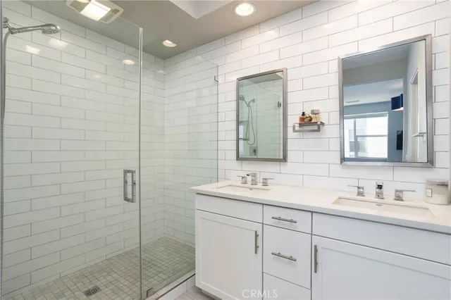 a bathroom with a shower sink and mirror