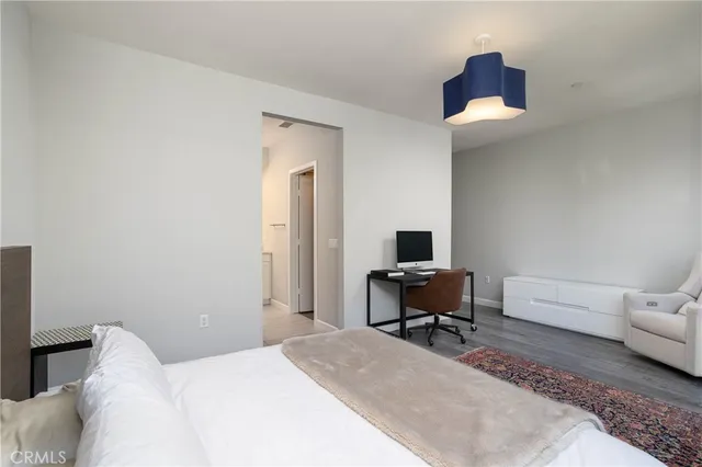 a bedroom with a bed and a chair