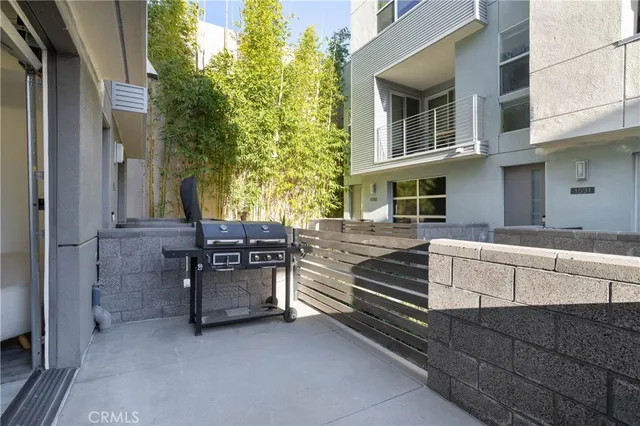 a view of a chairs and table in the balcony