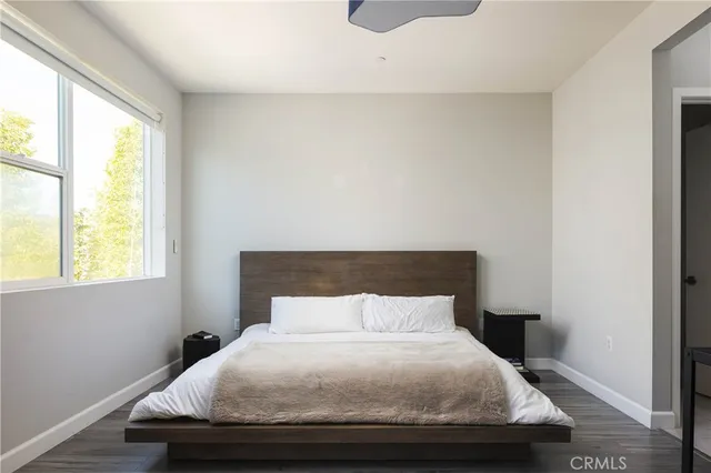 a bedroom with a bed and window