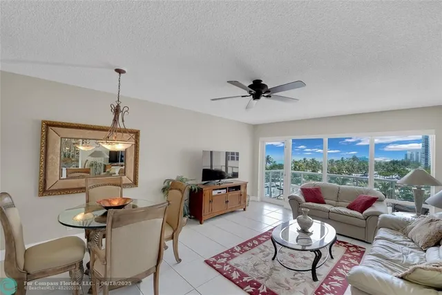a bedroom with a large bed and a flat tv screen on dresser