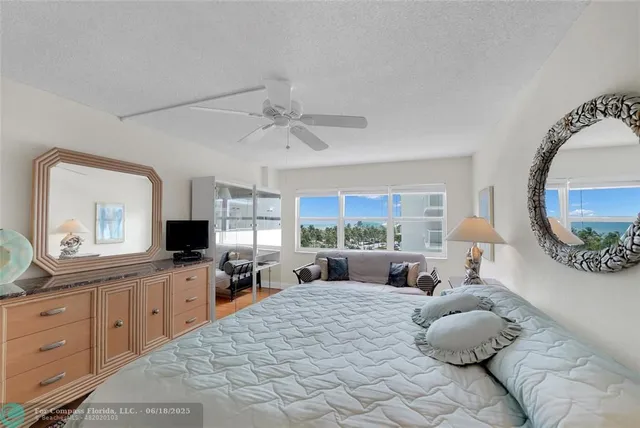 a view of a lake with lawn chairs and a table