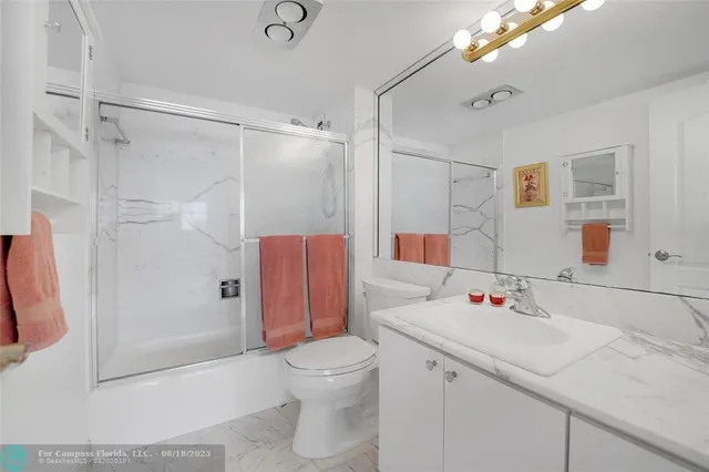 a kitchen with stainless steel appliances granite countertop a sink and a refrigerator