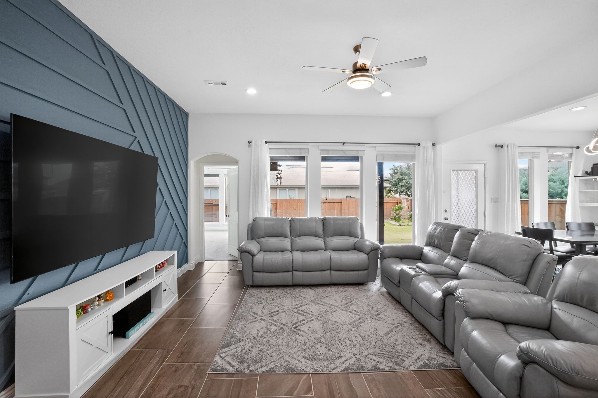 400 Cortona Lane Georgetown, TX 78628 - Photo 12 of 40 Living area featuring a ceiling fan, arched walkways, recessed lighting, and wood finish floors