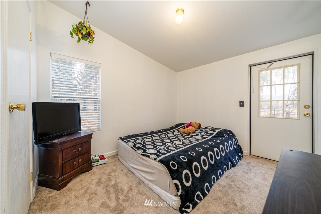25 Caudill Road Omak, WA 98841 - Photo 12 of 40 a bedroom with a bed and a flat screen tv