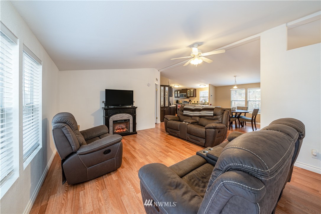 25 Caudill Road Omak, WA 98841 - Photo 19 of 40 a living room with furniture a flat screen tv and wooden floor