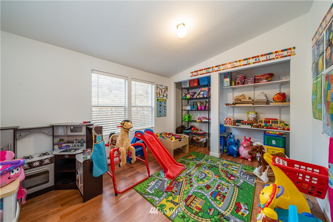 25 Caudill Road Omak, WA 98841 - Photo 22 of 40 a living room filled with a baby crib furniture and a wooden floor