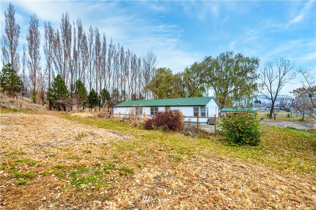 25 Caudill Road Omak, WA 98841 - Photo 35 of 40 a view of a house with backyard and trees