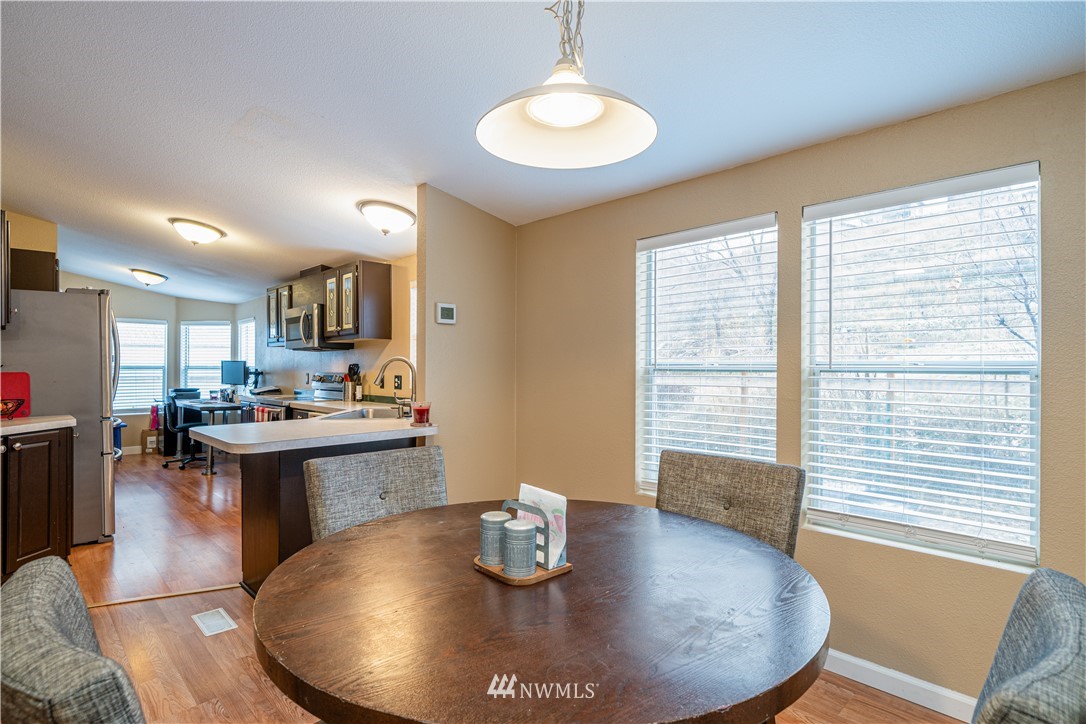25 Caudill Road Omak, WA 98841 - Photo 9 of 40 a kitchen with a stove a sink and a dining table
