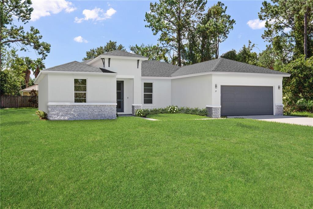 16094 Southwest 42nd Terrace Ocala, FL 34473 - Photo 3 of 17 a front view of a house with a garden and yard