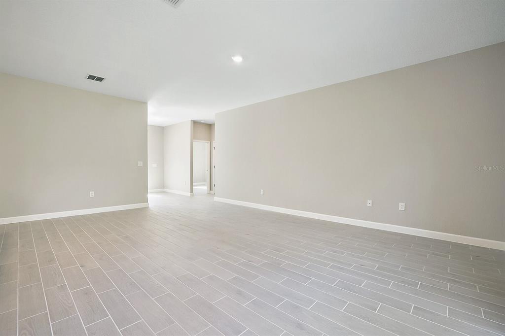 16094 Southwest 42nd Terrace Ocala, FL 34473 - Photo 7 of 17 a view of an empty room with wooden floor