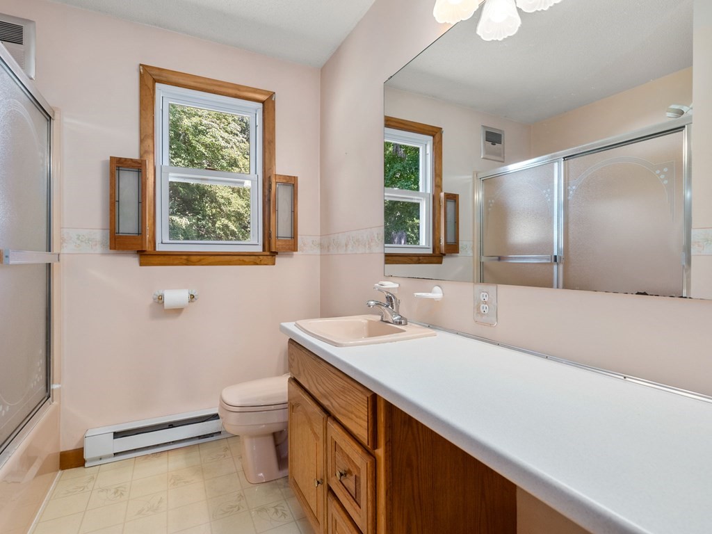 16 May Road Ludlow, MA 01056 - Photo 14 of 28 a bathroom with a sink a toilet and a mirror