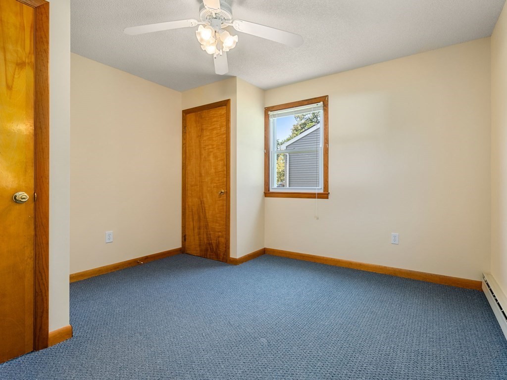 16 May Road Ludlow, MA 01056 - Photo 18 of 28 a view of an empty room with wooden floor and a window