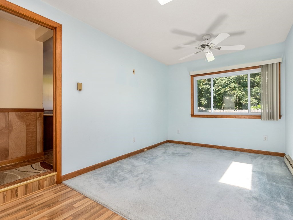 16 May Road Ludlow, MA 01056 - Photo 2 of 28 an empty room with wooden floor fan and windows
