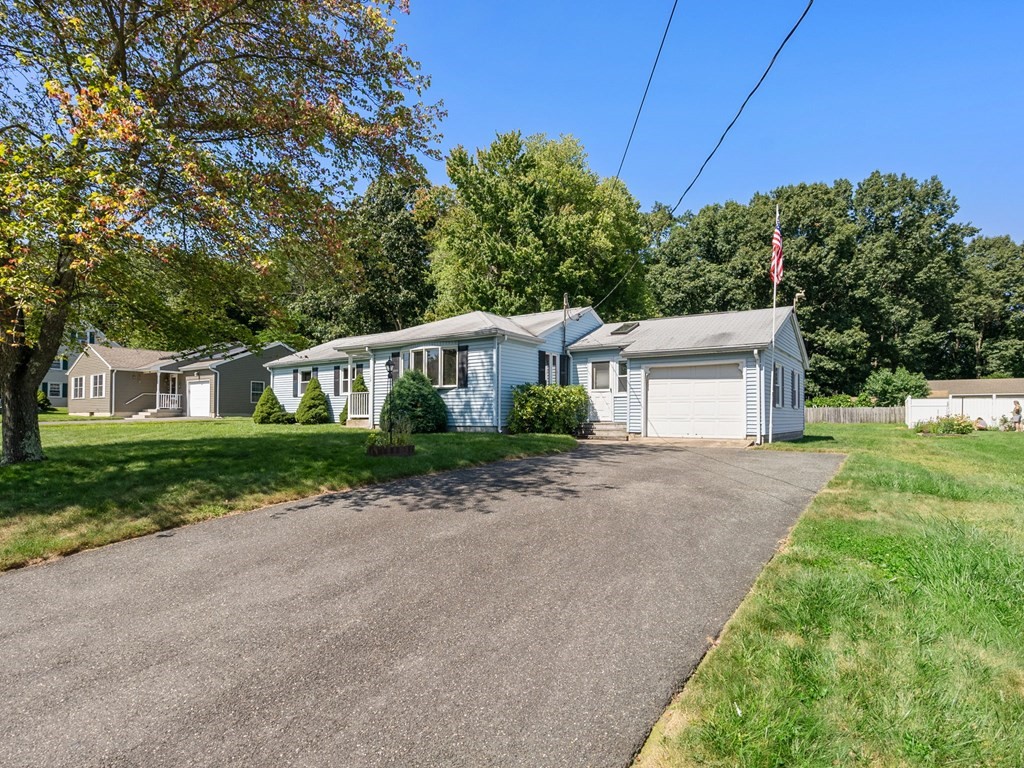16 May Road Ludlow, MA 01056 - Photo 26 of 28 a front view of a house with a yard and a garage