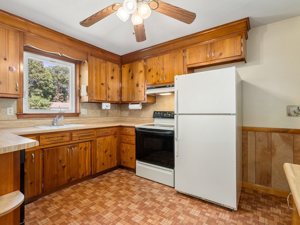 16 May Road Ludlow, MA 01056 - Photo 7 of 28 a kitchen with stainless steel appliances granite countertop a refrigerator a sink dishwasher a stove with white cabinets and wooden floor