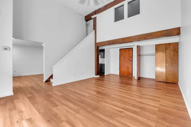 a kitchen with a table chairs microwave and cabinets