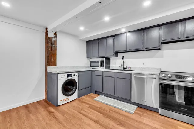 a view of a room with wooden floor and staircase