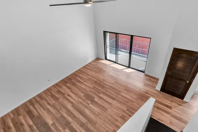 a bedroom with a bed and a potted plant