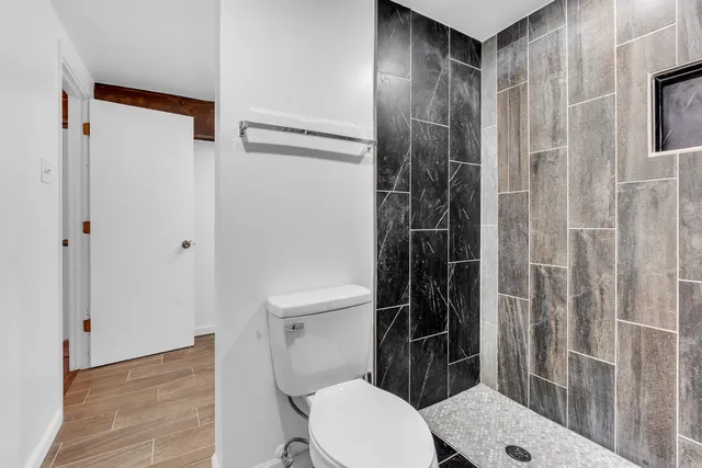 a bedroom with a bed and a mirror