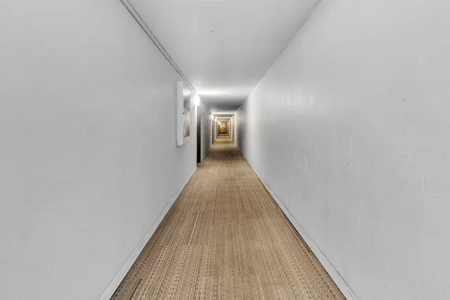 a view of a room with wooden floor and furniture