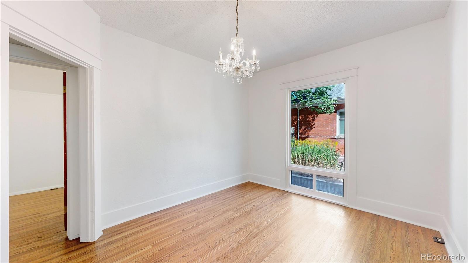 4169 Hooker Street Denver, CO 80211 - Photo 15 of 48 wooden floor in an empty room with a window