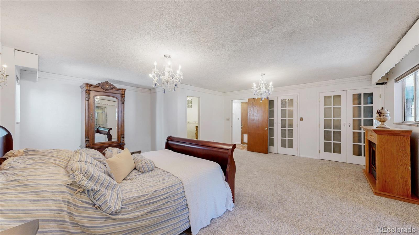 4169 Hooker Street Denver, CO 80211 - Photo 20 of 48 a spacious bedroom with a bed and a mirror on dresser