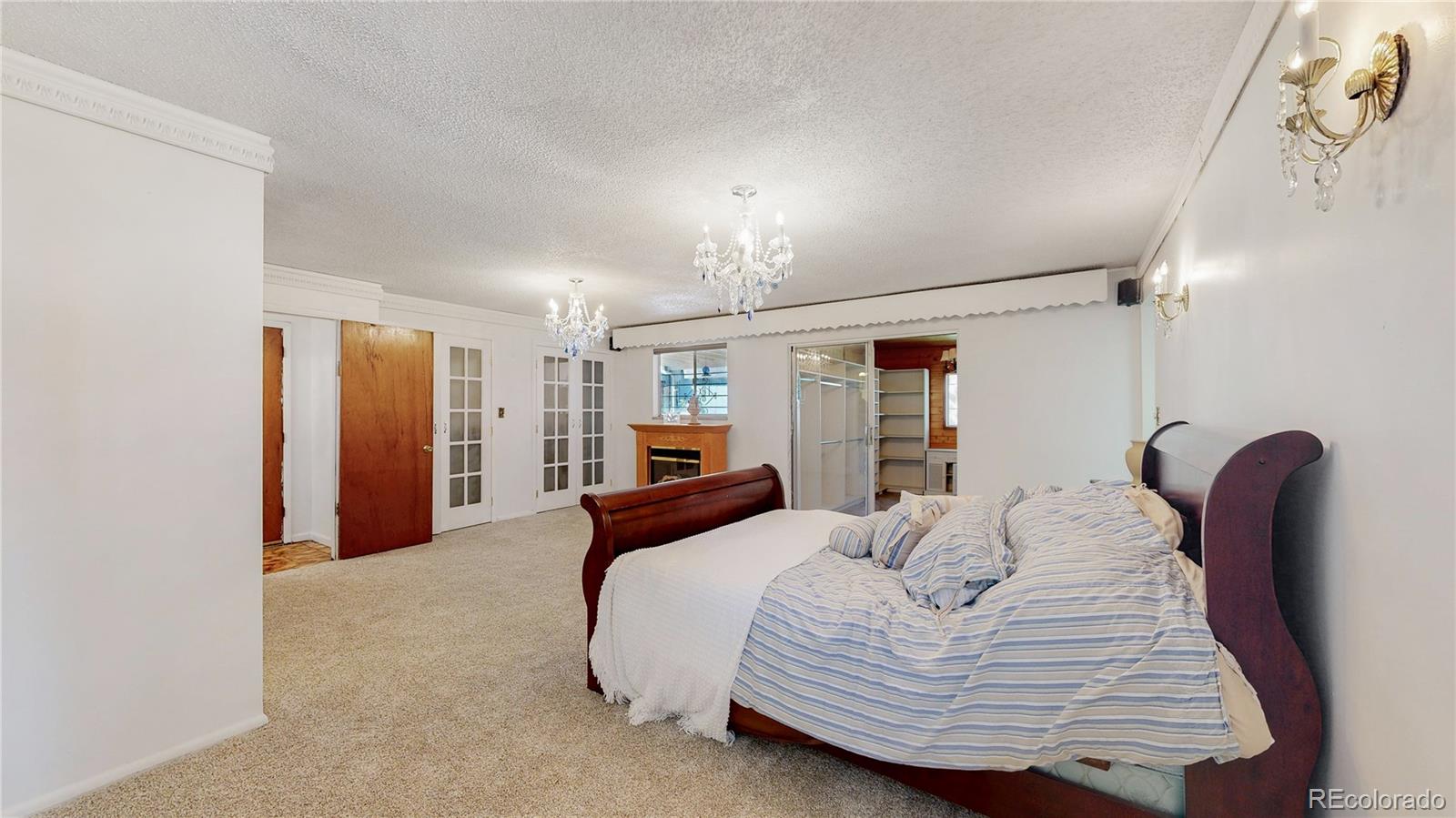 4169 Hooker Street Denver, CO 80211 - Photo 21 of 48 a bedroom with a bed and a chandelier