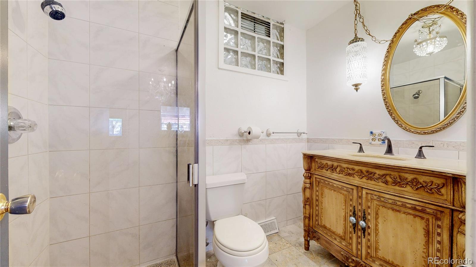 4169 Hooker Street Denver, CO 80211 - Photo 23 of 48 a bathroom with a sink a toilet and a mirror