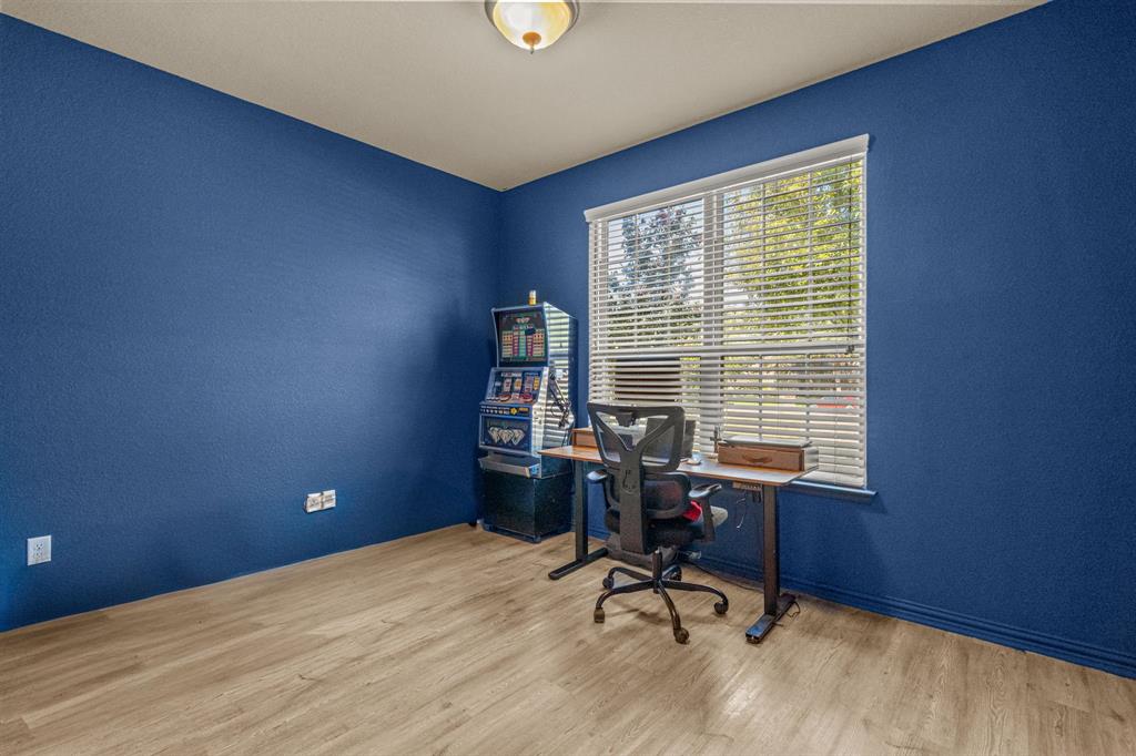 108 Bosque Court Azle, TX 76020 - Photo 16 of 33 a view of a workspace with furniture and a window