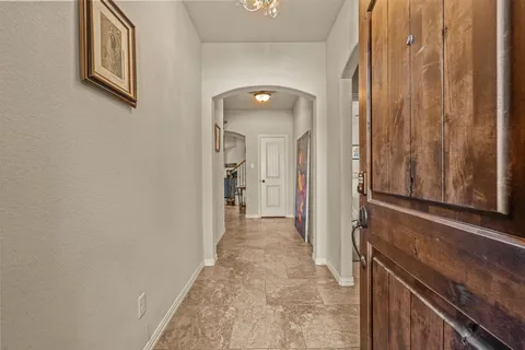 a view of a hallway with wooden shelves