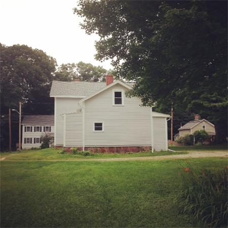 269 Riverside Drive Northampton, MA 01062 - Photo 5 of 28 a front view of a house with a garden and yard