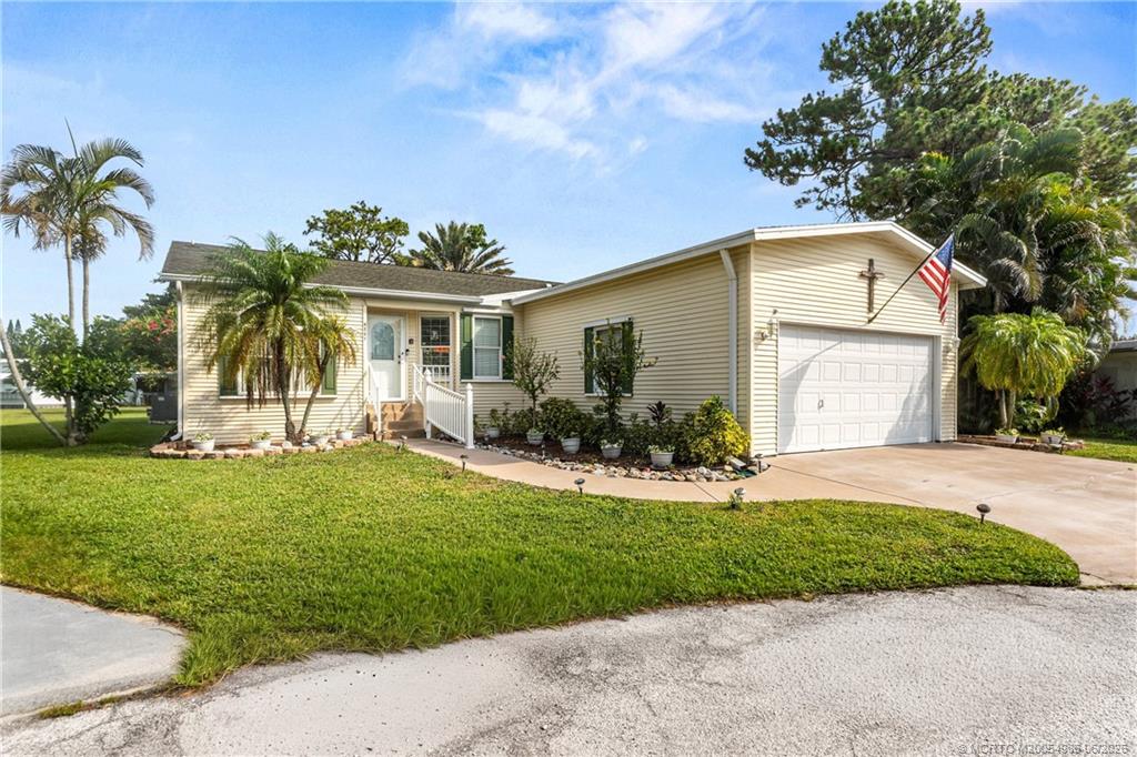 4237 4th Court Lantana, FL 33462 - Photo 3 of 40 a front view of a house with a yard and garage