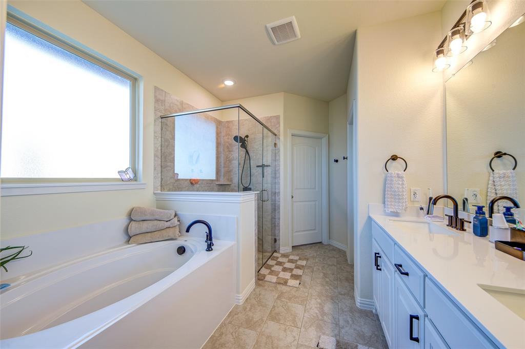 131 Clear Crk Lane Rhome, TX 76078 - Photo 14 of 29 Full bathroom with double vanity, a bath, and a shower stall