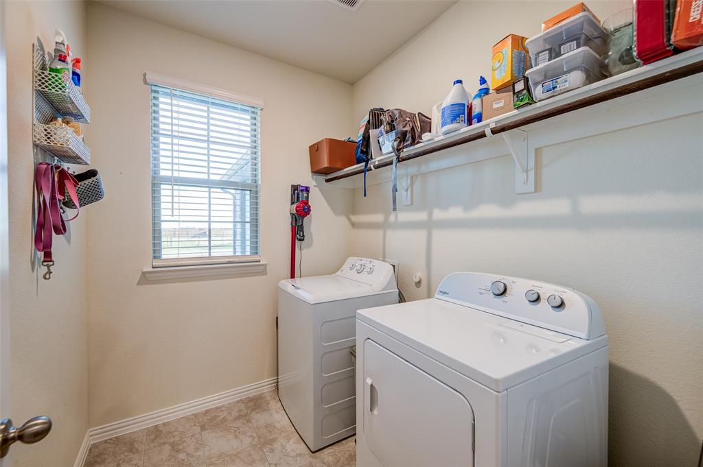 131 Clear Crk Lane Rhome, TX 76078 - Photo 22 of 29 Laundry area with washer and clothes dryer and baseboards