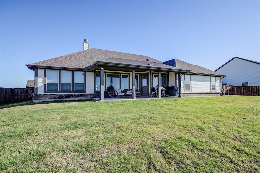 131 Clear Crk Lane Rhome, TX 76078 - Photo 26 of 29 Rear view of house featuring a fenced backyard, a patio, a chimney, and a shingled roof