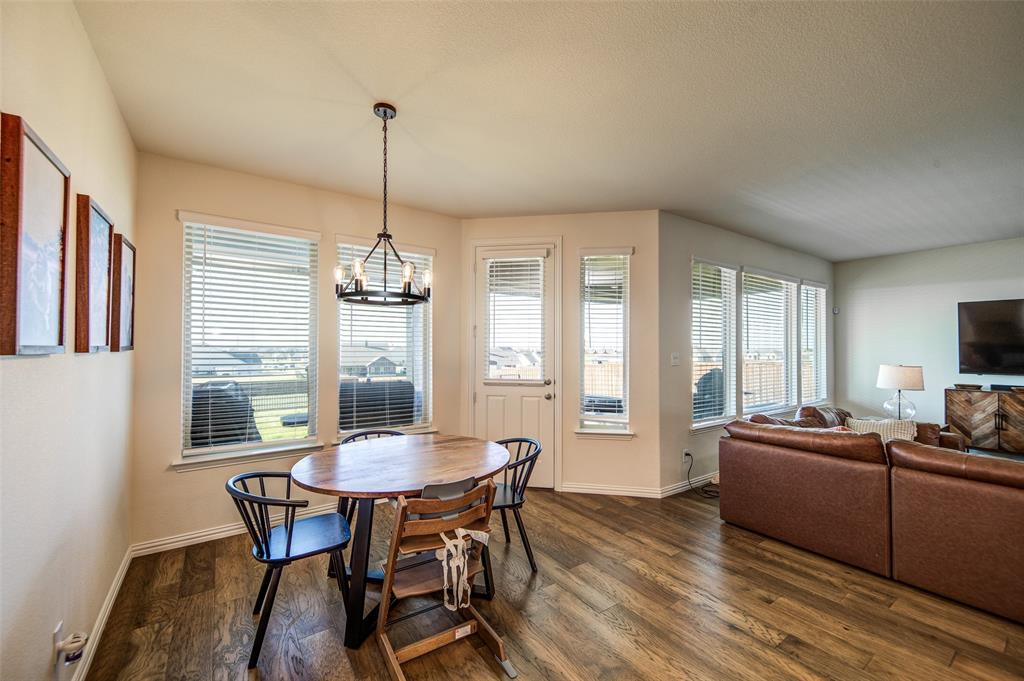 131 Clear Crk Lane Rhome, TX 76078 - Photo 10 of 29 Dining area featuring dark wood-style flooring, plenty of natural light, a chandelier, and a textured ceiling